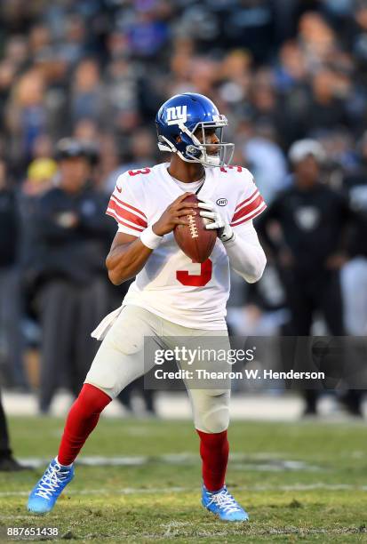 Geno Smith of the New York Giants drops back to pass against the Oakland Raiders during their NFL football game at Oakland-Alameda County Coliseum on...