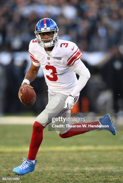 Geno Smith of the New York Giants scrambles with the ball against the Oakland Raiders during their NFL football game at Oakland-Alameda County...