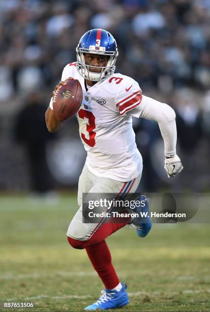 Geno Smith of the New York Giants scrambles with the ball against the Oakland Raiders during their NFL football game at Oakland-Alameda County...