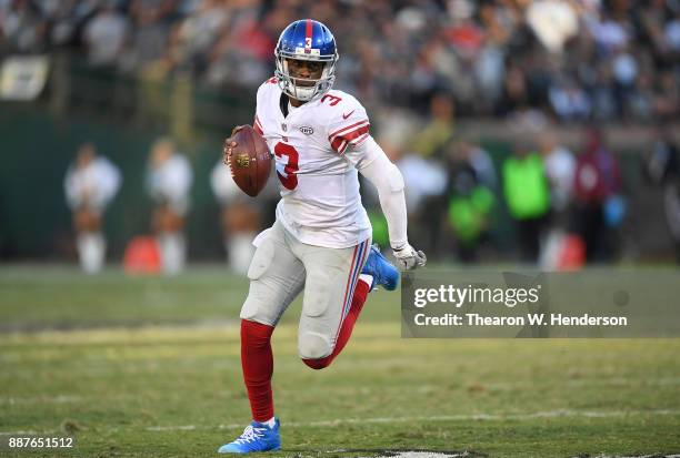 Geno Smith of the New York Giants scrambles with the ball against the Oakland Raiders during their NFL football game at Oakland-Alameda County...