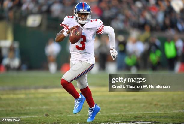 Geno Smith of the New York Giants scrambles with the ball against the Oakland Raiders during their NFL football game at Oakland-Alameda County...