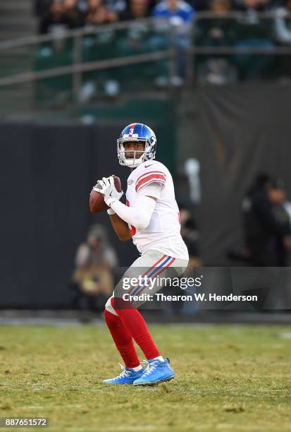 Geno Smith of the New York Giants drops back to pass against the Oakland Raiders during their NFL football game at Oakland-Alameda County Coliseum on...