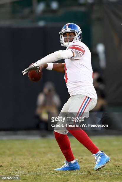 Geno Smith of the New York Giants drops back to pass against the Oakland Raiders during their NFL football game at Oakland-Alameda County Coliseum on...
