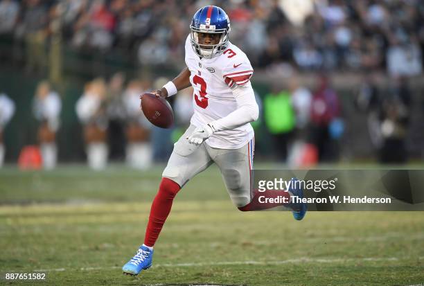 Geno Smith of the New York Giants scrambles with the ball against the Oakland Raiders during their NFL football game at Oakland-Alameda County...