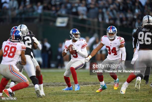 Geno Smith of the New York Giants drops back to pass against the Oakland Raiders during their NFL football game at Oakland-Alameda County Coliseum on...