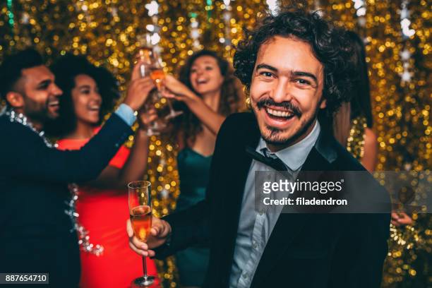 man at a new year's eve party - men of the year party inside stock pictures, royalty-free photos & images