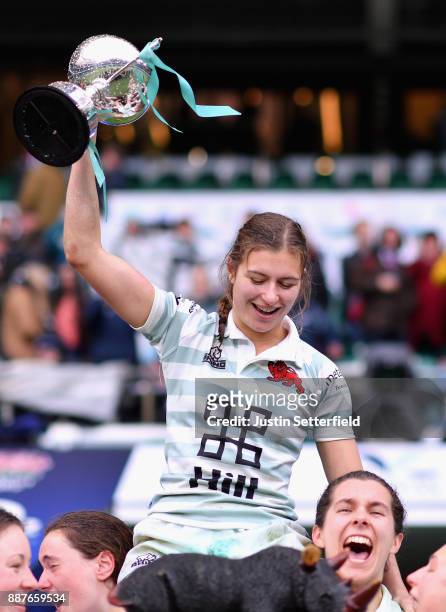 Lara Gibson of Cambridge and her team mates celebrate as they lift the trophy following victory in the Oxford University vs Cambridge University...