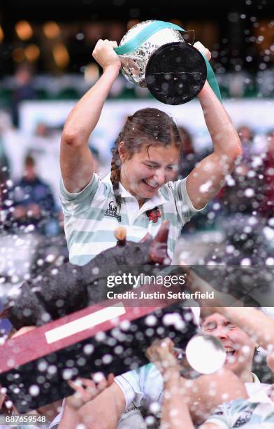 Lara Gibson of Cambridge and her team mates celebrate as they lift the trophy following victory in the Oxford University vs Cambridge University...