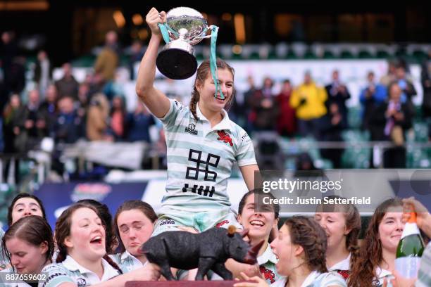 Lara Gibson of Cambridge and her team mates celebrate as they lift the trophy following victory in the Oxford University vs Cambridge University...