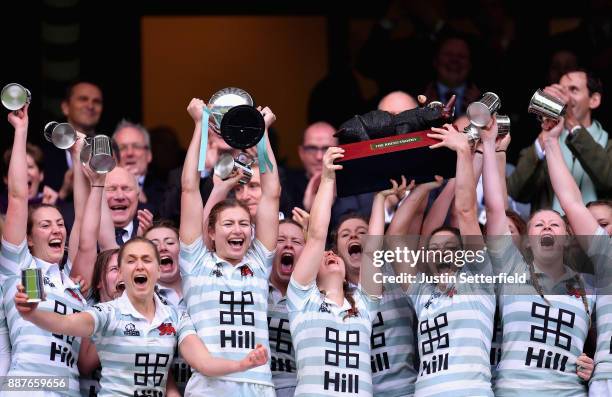 Lara Gibson of Cambridge and her team mates celebrate as they lift the trophy following victory in the Oxford University vs Cambridge University...