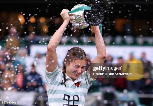 Lara Gibson of Cambridge and her team mates celebrate as they lift the trophy following victory in the Oxford University vs Cambridge University...