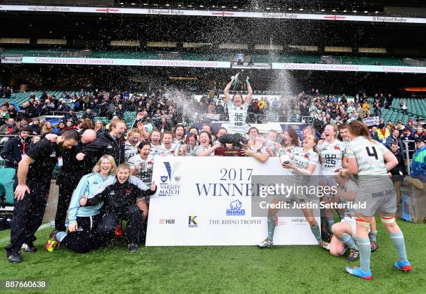 Lara Gibson of Cambridge and her team mates celebrate as they lift the trophy following victory in the Oxford University vs Cambridge University...