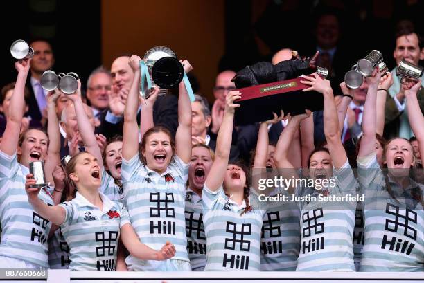 Lara Gibson of Cambridge and her team mates celebrate as they lift the trophy following victory in the Oxford University vs Cambridge University...