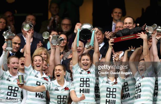 Lara Gibson of Cambridge and her team mates celebrate as they lift the trophy following victory in the Oxford University vs Cambridge University...