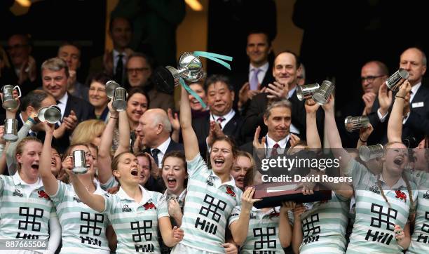 Lara Gibson of Cambridge and her team mates celebrate as they lift the trophy following victory in the Oxford University vs Cambridge University...