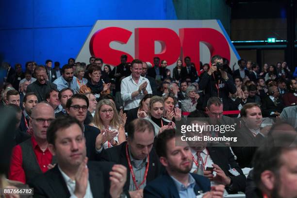 Attendees applaud Social Democrat Party leader Martin Schulz speaks during the SPD's federal party convention in Berlin, Germany, on Thursday, Dec....