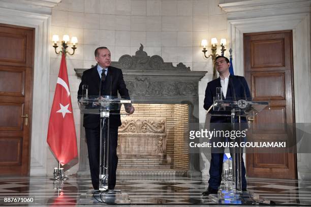 Greek Prime Minister Alexis Tsipras and Turkish President Recep Tayyip Erdogan deliver a joint press conference in Athens on December 7, 2017....