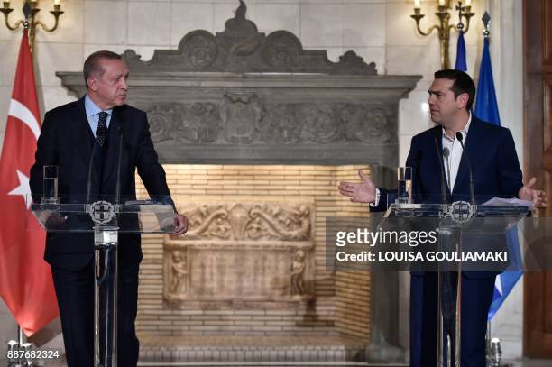 Greek Prime Minister Alexis Tsipras and Turkish President Recep Tayyip Erdogan deliver a joint press conference in Athens on December 7, 2017....