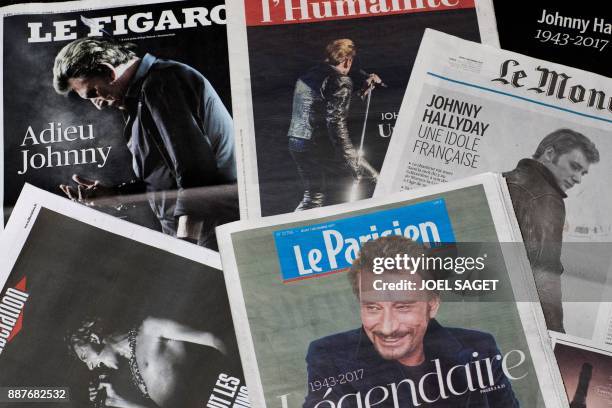 Front pages of French newspapers in tribute to late French singer Johnny Hallyday are displayed in Paris on December 7, 2017. - French music icon...