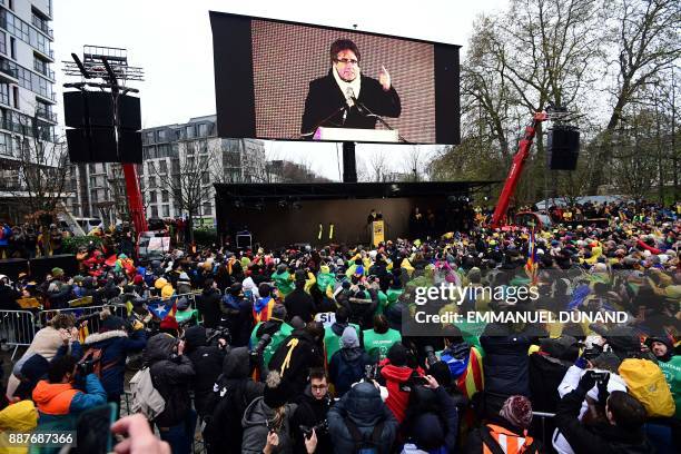 Supporters listen to the speech of Catalonia's deposed regional president Carles Puigdemont during a pro-independence demonstration on December 7,...
