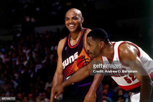 Charles Barkley of the Phoenix Suns smiles as Buck Williams of the Portland Trail Blazers prepares to box him out of the paint in Game Three of the...