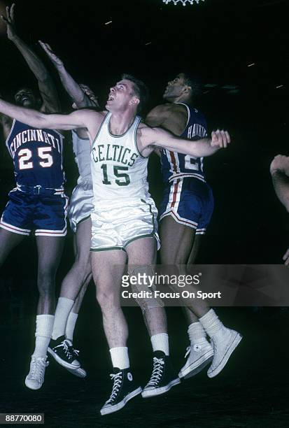 S: Tom Heinsohn of the Boston Celtics battles under the basket with Jay Arnette and Tom Thacker of the Cincinnati Royals during a mid circa 1960's...