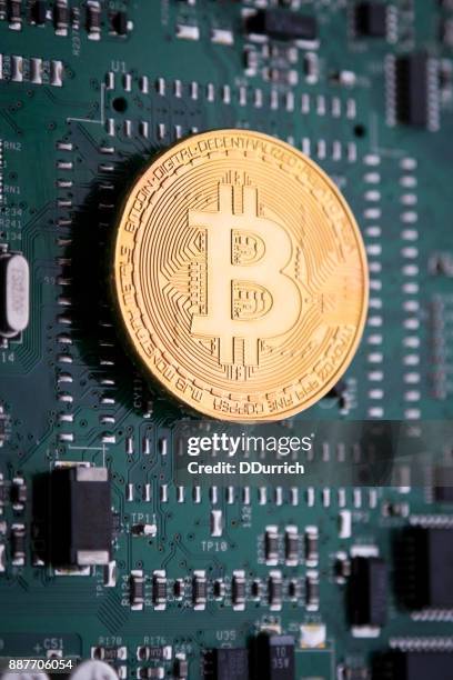 bitcoin cryptocurrency on a circuit board - circuit bank of brazil stock pictures, royalty-free photos & images