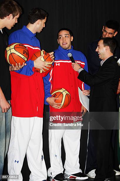 Dennis Katsanos of Sky TV questions Carlos Lopez and Raymond Cintron of Puerto Rico during the FIBA U19 World Championship captains photocall at the...