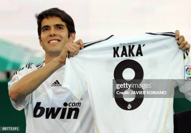 Real Madrid new player Brazilian midfielder Kaka shows his Real Madrid new jersey number 8 during his official presentation on June 30, 2009 at the...