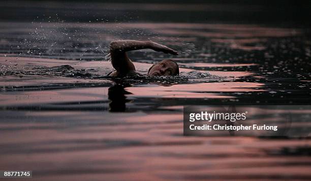 Lady Alice Douglas swims in Llyn Mymbyr at sunset in the shadow of the Snowdon Horseshoe in North Wales on June 30, 2009 in Capel Curig, United...
