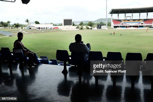 Displaced residents from the island of Barbuda sit inside a shelter at a cricket stadium on December 7, 2017 in St John's, Antiqua. Barbuda, which...
