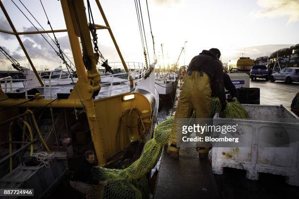 Fishermen load nets onto the St. Georges fishing trawler at sunrise in Newlyn harbor in Newlyn, U.K., on Tuesday, Nov. 28, 2017. Prime Minister...