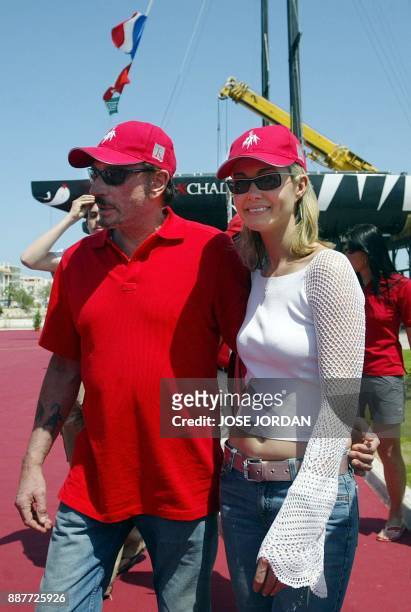 French singer Johnny Hallyday and his wife Laeticia are picture at the port of Gandia, in Valencia, 30 April 2005, prior to take part in a training...