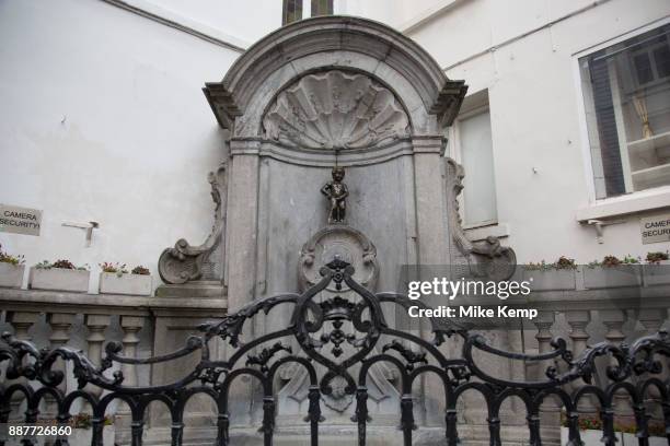 Manneken Pis, the urinating boy statue in central Brussels, Belgium. Manneken Pis is a landmark small bronze sculpture in Brussels, depicting a naked...