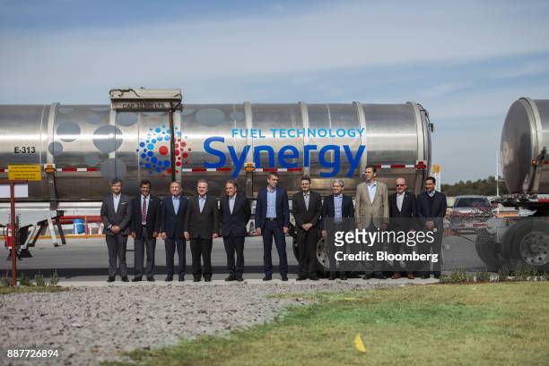 Pedro Joaquin Coldwell, Mexico's energy minister, forth left, stands with executives in front of a fuel tanker during the unveiling of the Exxon...
