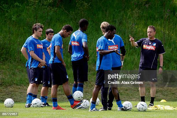 Players watch head coach Ralf Rangnick gesture during a training session of 1899 Hoffenheim during a training camp on July 1, 2009 in Stahlhofen am...