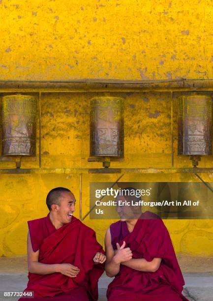 Monks debating in front of prayer wheels in a Rongwo monastery, Tongren County, Longwu, China on October 27, 2017 in Longwu, China.