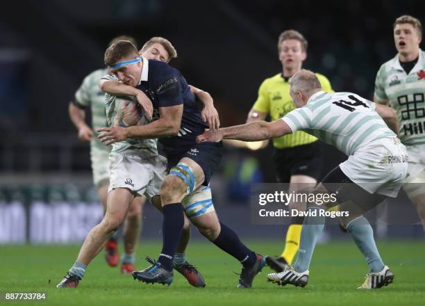 Noah Miller of Oxford University is tackled by Nick Koster and Charlie Amesbury of Cambridge University during the Oxford University vs Cambridge...