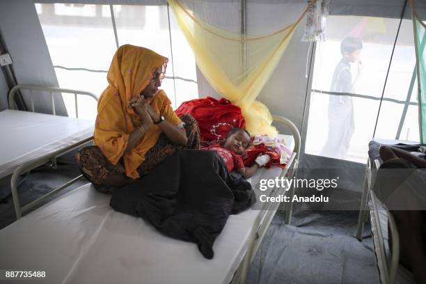 Rohingya baby, who fled from oppression within ongoing military operations in Myanmars Rakhine state, is seen as she waits to receive medical...