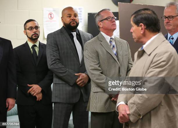 From left, defendants John Raposo, Derek Howard and George Billadeau stand in a waiting room during a visit to the Bridgewater State Hospital in...