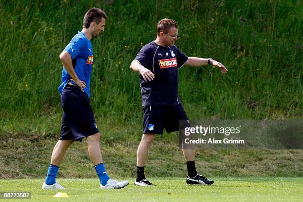 Head coach Ralf Rangnick gestures as he stands next to Vedad Ibisevic during a training session of 1899 Hoffenheim during a training camp on July 1,...