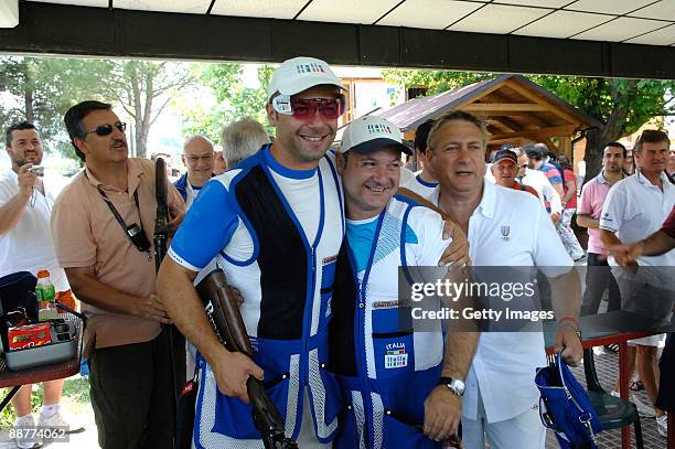 Daniele Di Spigno of Italy celebrates victory with Francesco D'Aniello of Italy and the coach Mirco Cenci after competing in the Men's Double Trap at...