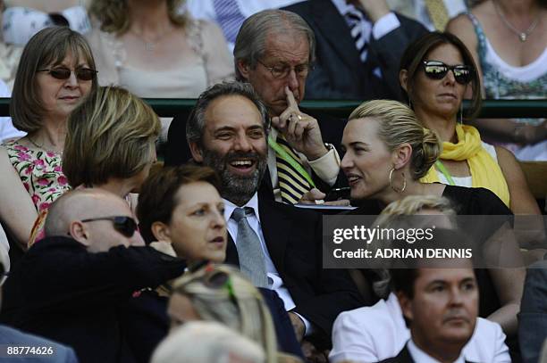 Actress Kate Winslet and her husband Sam Mendes attend a tennis match between Croatia's Ivo Karlovic and Switzerland's Roger Federer on Day 9 at the...