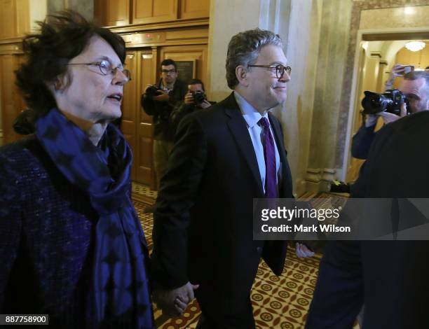 Sen. Al Franken walks with his wife Franni Bryson, to the Senate chamber to announce his resignation, Capitol Hill, on December 7, 2017 on Capitol...