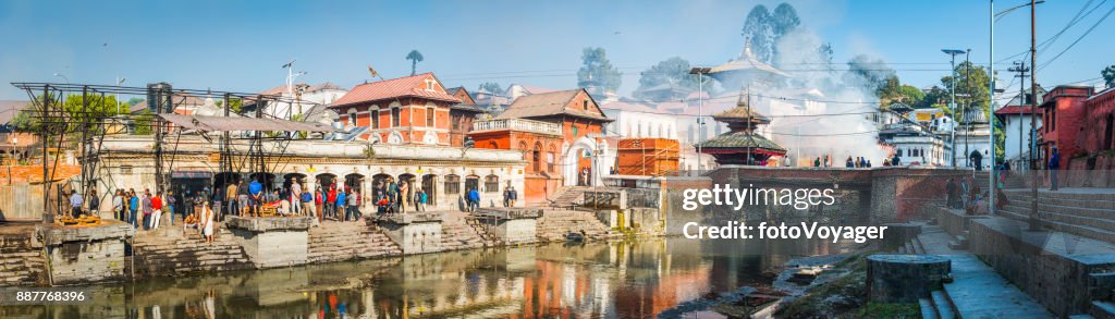 Kathmandu Pashupatinath Hindu funeral ghats mourners on riverbanks panorama Nepal