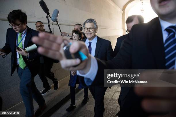 Sen. Al Franken ) leaves the U.S. Capitol with his wife Franni Bryson after speaking on the floor of the U.S. Senate December 7, 2017 in Washington,...