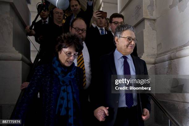 Senator Al Franken, a Democrat from Minnesota, right, walks out of the U.S. Capitol with his wife Franni Bryson, left, after speaking on the Senate...