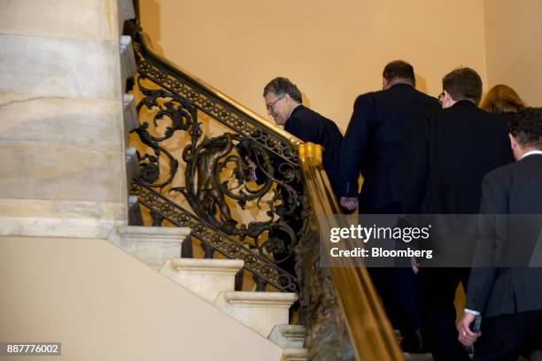 Senator Al Franken, a Democrat from Minnesota, center, walks through the U.S. Capitol before speaking on the Senate floor in Washington, D.C., U.S.,...