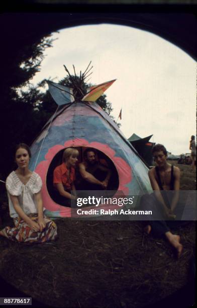 View of Woodstock Music Festival attendees sitting outside and within their tepee tent on the festival grounds, Bethel, NY, August 1969.