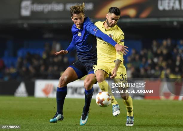 Maccabi Tel Aviv's forward Aaron Schoenfeld challenges Villarreal's midfielder Genis Montolio during the UEFA Europa League group A football match...